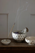 Ceramic incense holder by Moshi Moshi, minimalist handmade shape, smooth ceramic texture, neutral interior accent.