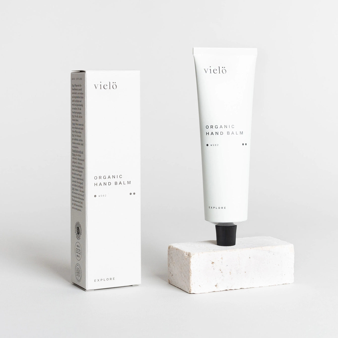 Hydrating organic hand balm by Vielö, minimalist tube design, creamy lotion texture with calendula, lavender, and sage botanical extracts, fast-absorbing skincare essential. 50 ml, crafted in Austria, premium moisturizing ritual.