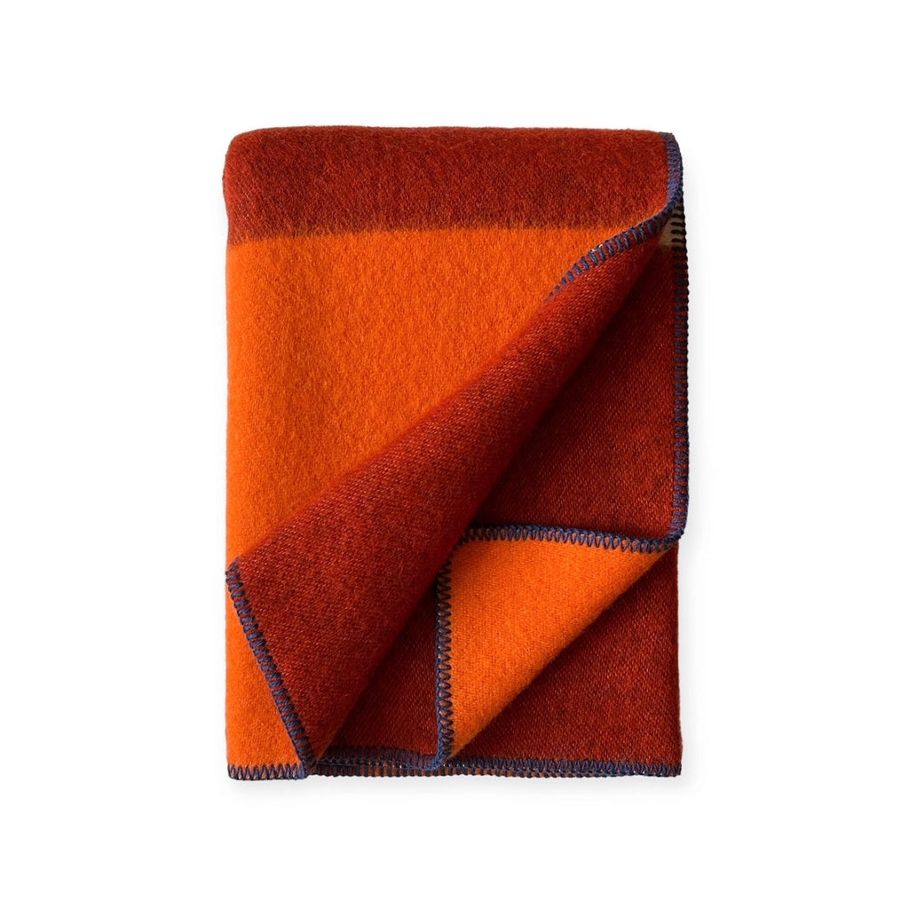 Reversible Norwegian merino wool plaid blanket in burgundy and orange tone, soft brushed texture, jacquard weave, artisanal home textile.